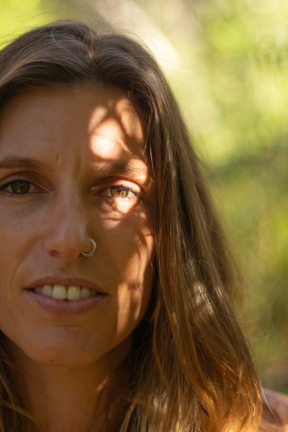 Close portrait of Madison Louise with dappled light across her face