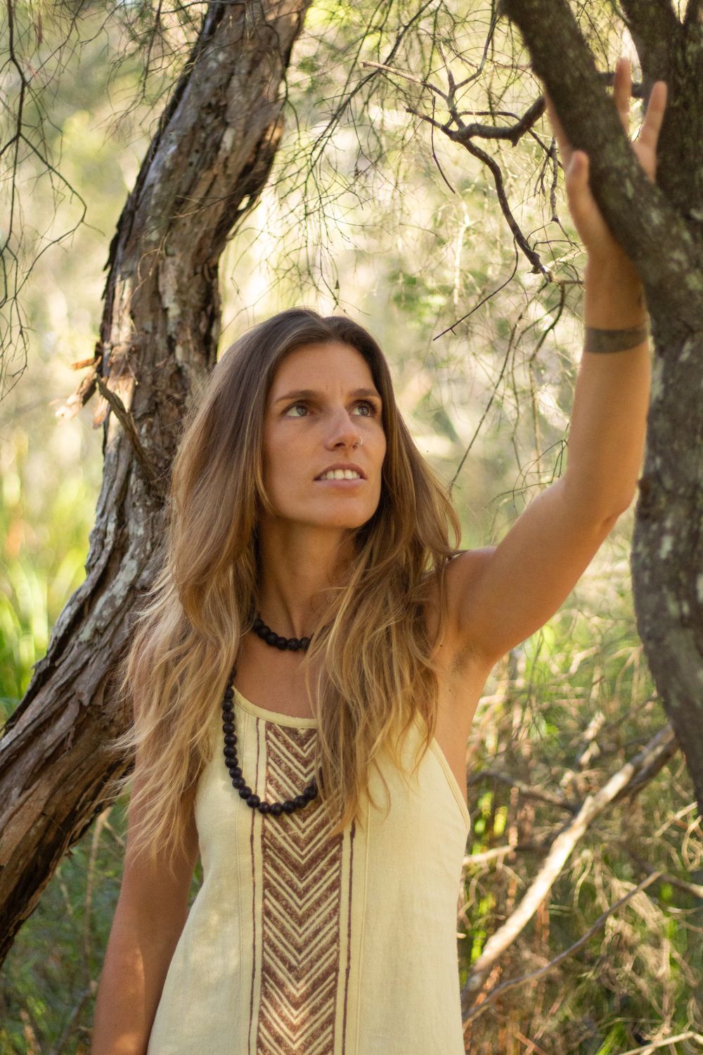 Portrait of Madison Louise reaching up to a tree