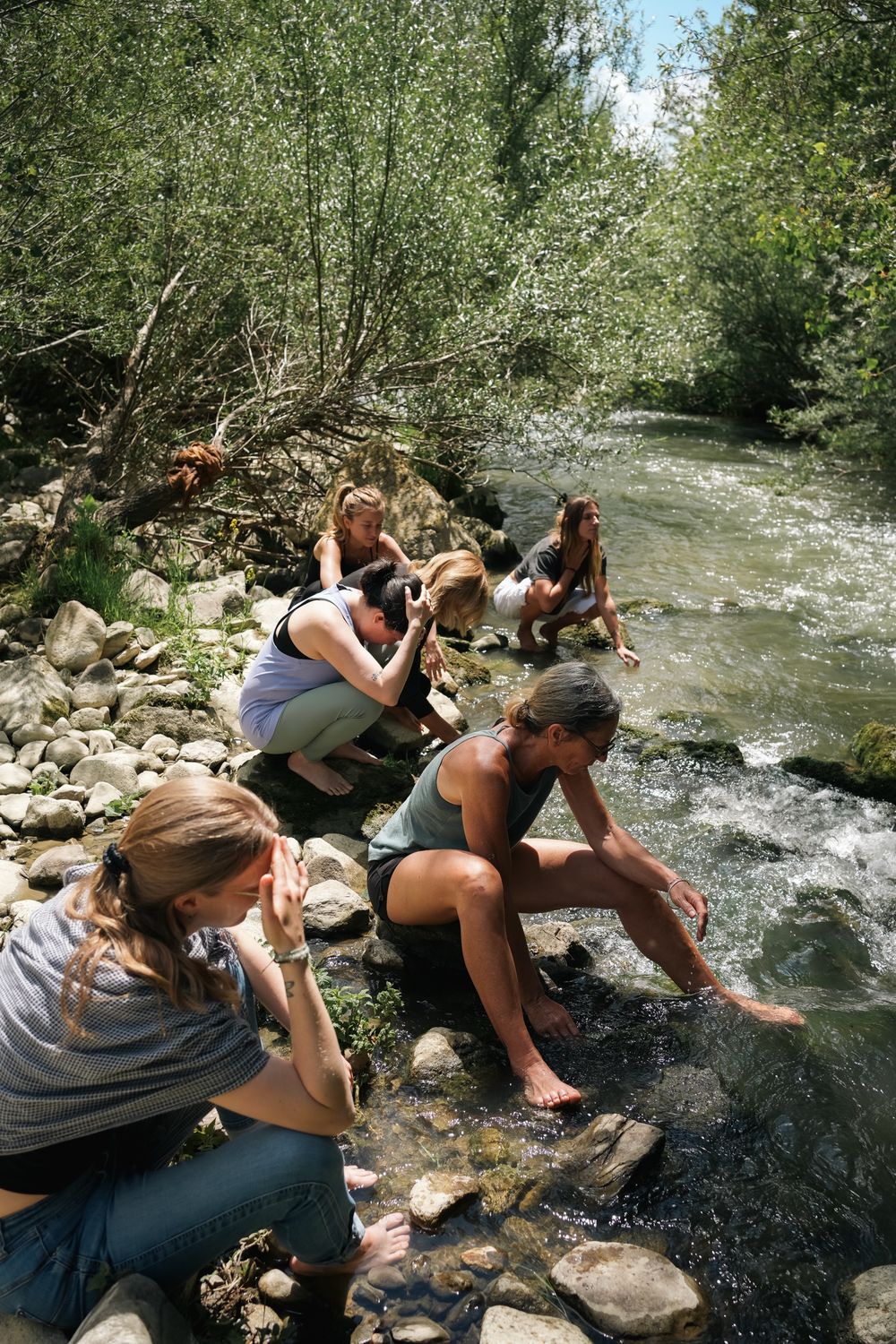 A training group working together beside a river